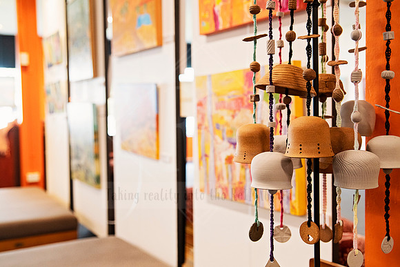 Rows of mounted artworks in exhibition hallway, part of Artwalk gallery setup imagery.