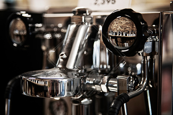 Close-up of espresso machine pressure gauge and chrome fittings at Dipacci Coffee PMQ.
