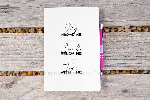 Notebook on timber table with affirmation: “Stay above me. Earth below me. Fire within me,” styled detail for Bron Watson & Co.