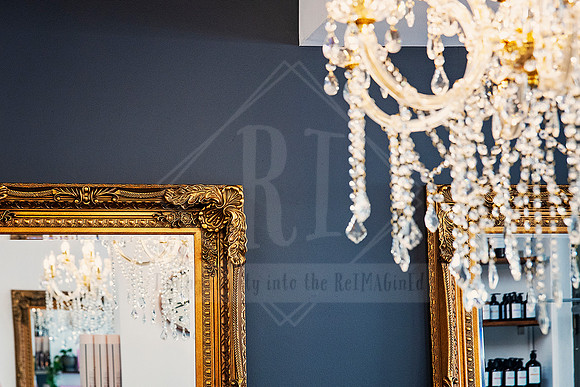Framed mirrors and chandelier strands layered in soft focus for a touch of glam.