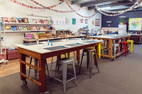 Tables prepared for a surrealist collage workshop at The Papery.