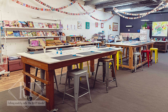 Tables prepared for a surrealist collage workshop at The Papery.