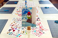 Workshop table set up with collage materials and refreshments.