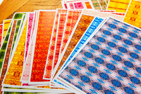 Collection of colourful patterned papers prepared for a handmade gift tag workshop.