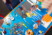 Paper craft materials and decorative embellishments used during a gift tag making class.