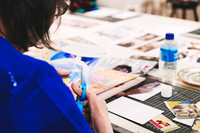 Participant arranging images for a surrealist collage project.
