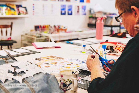 Participant selecting materials for a paper collage artwork.
