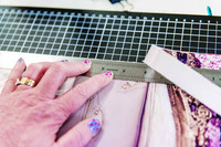 Measuring and preparing pages during a handmade journal workshop.