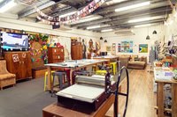 Inside The Papery with colourful papers, artwork and workshop tables.