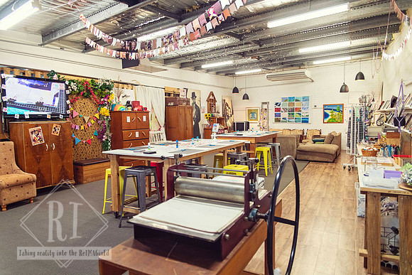 Inside The Papery with colourful papers, artwork and workshop tables.