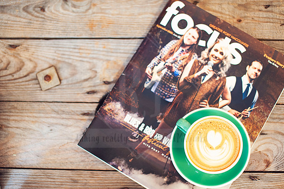 Flat lay featuring Focus magazine, coffee, and wood background—photographed to reflect cozy brand storytelling.