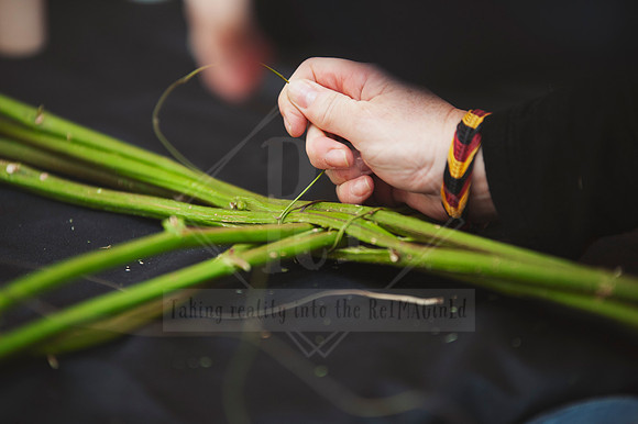 Close-up of hands weaving plant material during creative workshop, captured for content marketing by Reimagined Images.