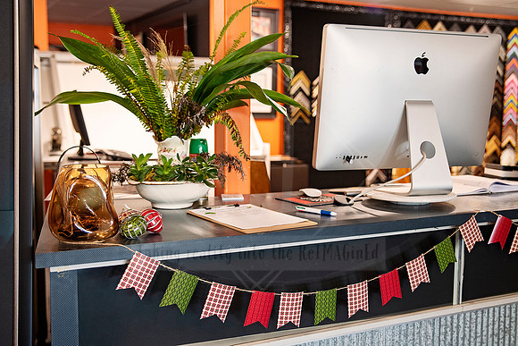 Desktop workspace with greenery and gift items at Sunset Framing & Gallery.