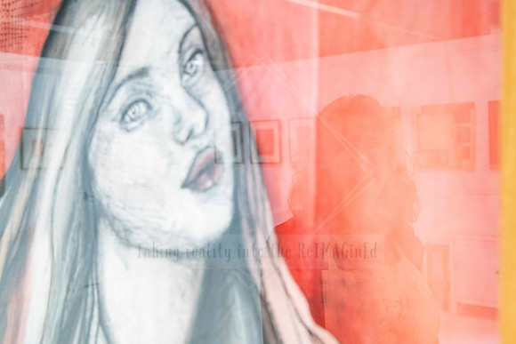 Artwork reflection of a woman overlaid with a pencil-drawn female portrait, visually layered photo for Artwalk exhibition promo.