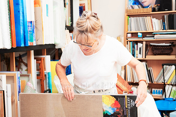 Artist unpacking canvases in a working studio, captured for authentic content marketing during Art Walk.