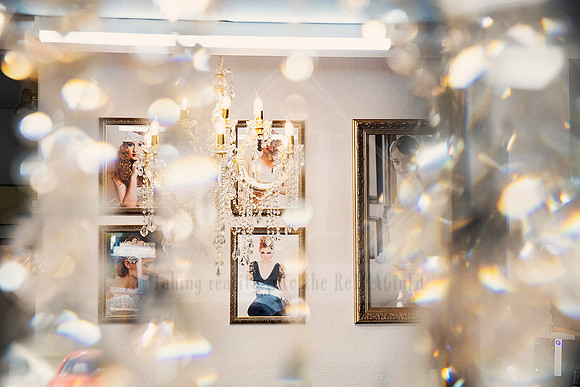 Sparkling crystals in foreground framing softly blurred portraits and lighting in background.