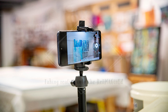 Tripod-mounted phone filming art creation process in Yvonne Kiely's working studio.