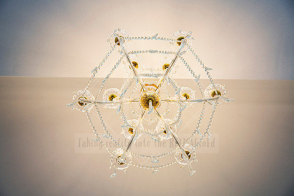 Unique star-shaped ceiling light fixture made of delicate glass and brass.