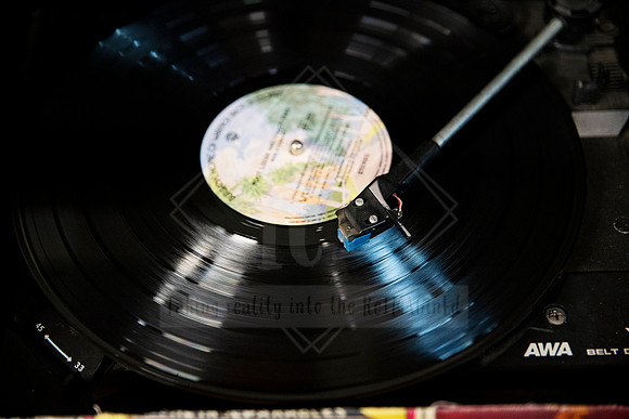 Turntable playing vinyl record, nostalgic close-up captured for Artwalk’s music culture narrative.