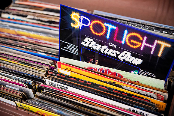 Crate of vintage vinyls featuring “Spotlight on Status Quo,” styled image for Artwalk’s music and culture series.