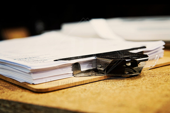 Clipboards stacked with paper and pens ready for use, styled detail shot for Artwalk workshop documentation.