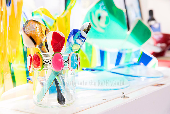 Bright still life of colourful glass tools in a jar, styled for promotional use in Artwalk media.