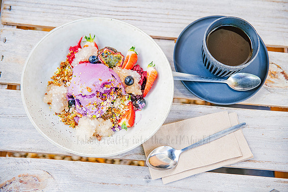 Bowl of granola and smoothie topped with fruit, styled brunch scene for wellness lifestyle brand Bron Watson & Co.
