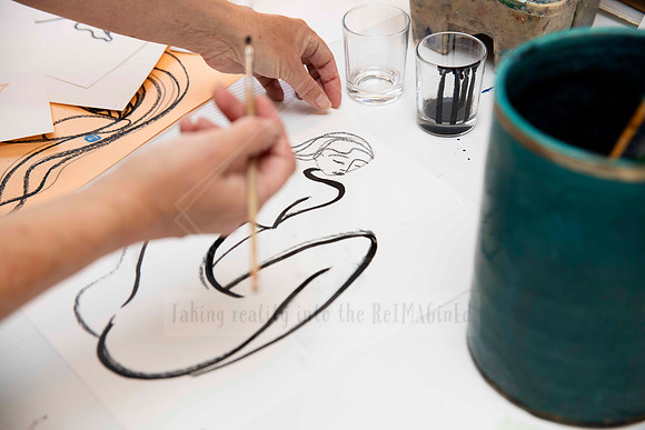 Hand painting expressive brush strokes on paper, content image showcasing creative process for Artwalk print and socials.